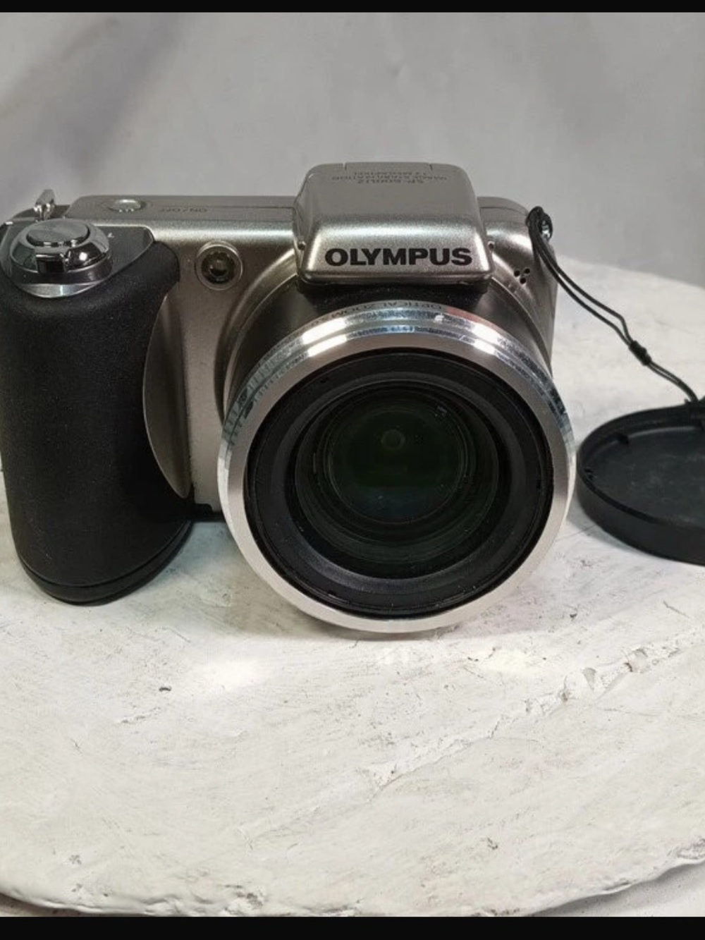 Olympus Silver Digital Camera with Black Grip and Lens Cap